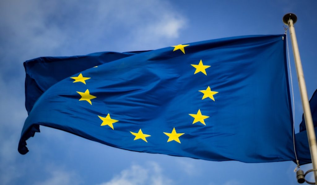 Flag of the European Union in front of the EU Parliament in Brussels, representing EU packaging regulation