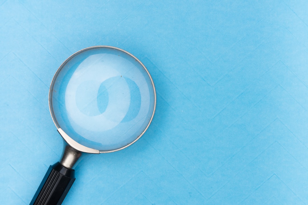 Magnifying glass over a document, representing verification of supplier certification claims
